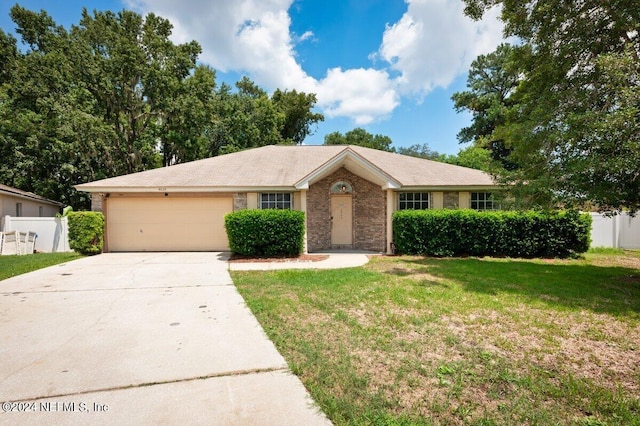 ranch-style home featuring a garage and a front lawn