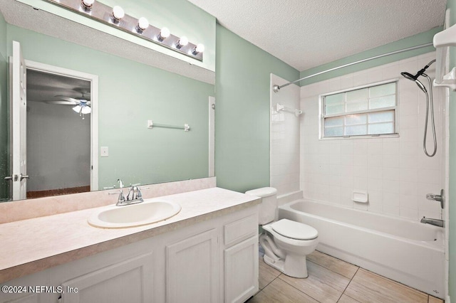 full bathroom featuring ceiling fan, toilet, tile patterned flooring, vanity, and tiled shower / bath combo