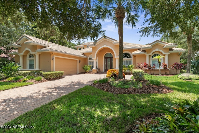 mediterranean / spanish-style home with a front yard