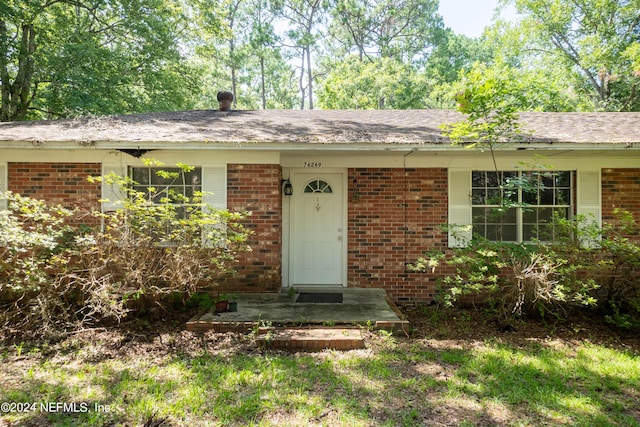 entrance to property with brick siding