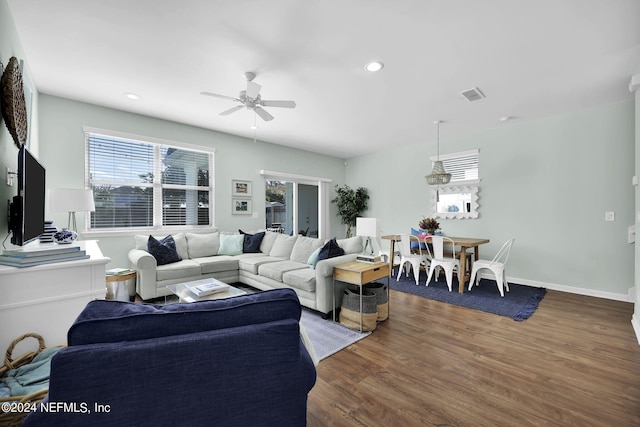 living room with ceiling fan and hardwood / wood-style flooring