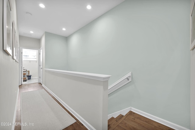 hallway with hardwood / wood-style flooring