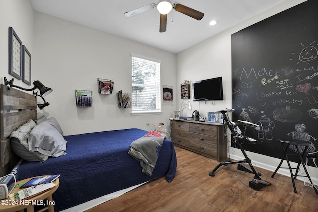 bedroom with ceiling fan and hardwood / wood-style flooring