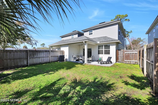 back of house featuring a patio, a yard, and cooling unit