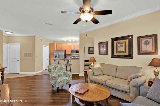 living room with dark wood-style flooring, visible vents, and crown molding