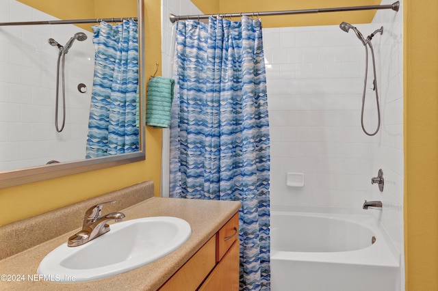 bathroom with shower / bath combo with shower curtain and vanity