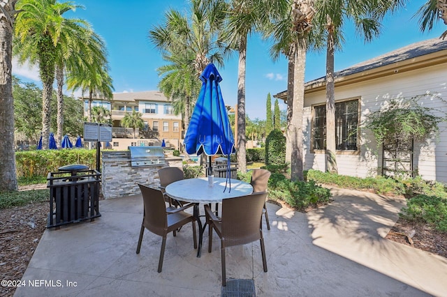 view of patio featuring outdoor dining space, grilling area, and area for grilling