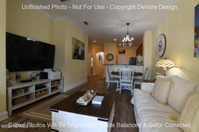 living area with a chandelier, visible vents, crown molding, and wood finished floors