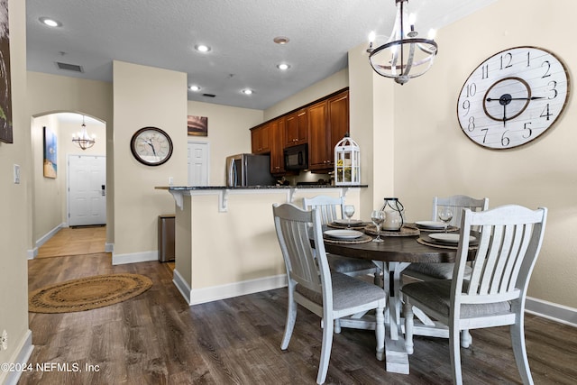 dining room featuring baseboards, visible vents, arched walkways, and dark wood-style flooring