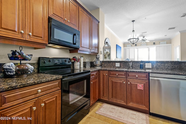 kitchen featuring visible vents, ornamental molding, a sink, dark stone counters, and black appliances