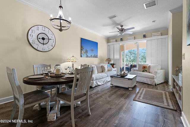 living room with a textured ceiling, ceiling fan with notable chandelier, wood finished floors, visible vents, and crown molding