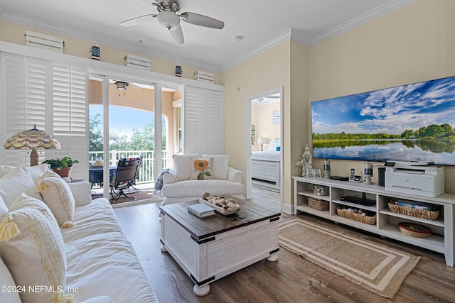 living room with ornamental molding, a ceiling fan, a textured ceiling, and wood finished floors