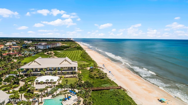 birds eye view of property featuring a water view and a beach view