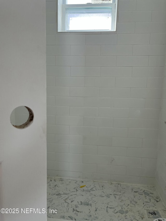 bathroom with tiled shower