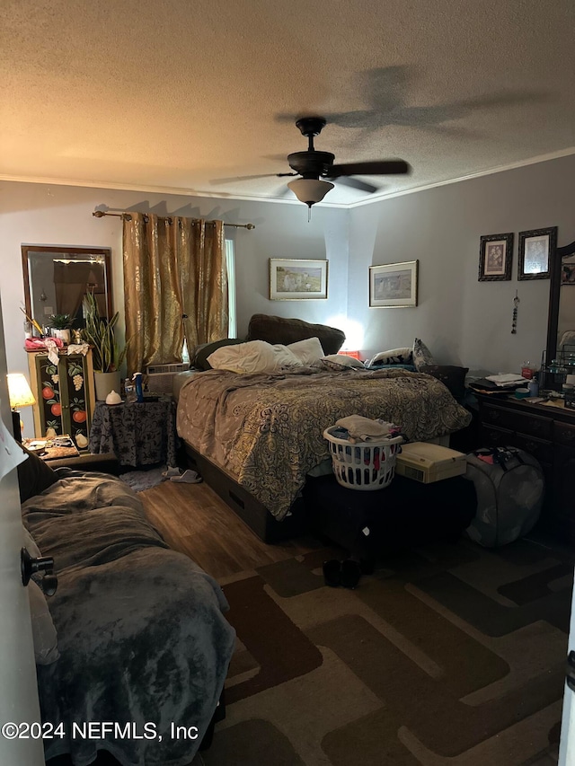 carpeted bedroom with a textured ceiling and ceiling fan