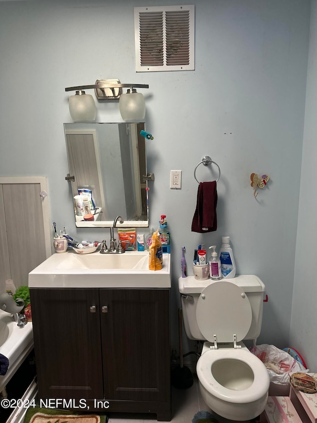 bathroom with toilet and vanity