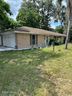 view of front facade with a front yard and a garage