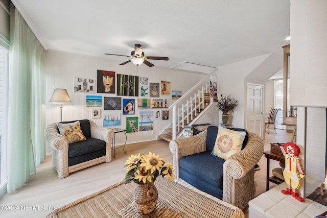 living room featuring wood-type flooring and ceiling fan