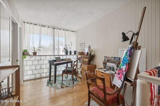 dining area featuring hardwood / wood-style floors and a textured ceiling