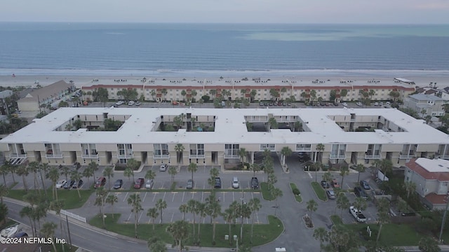 drone / aerial view featuring a water view and a beach view