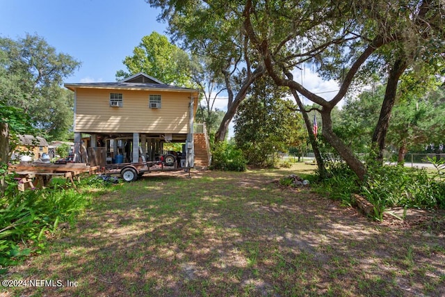 view of yard with a carport and stairway