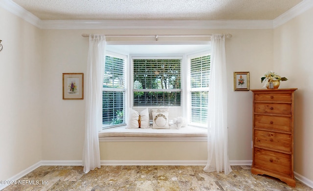 living area featuring a textured ceiling, a healthy amount of sunlight, and light tile patterned floors