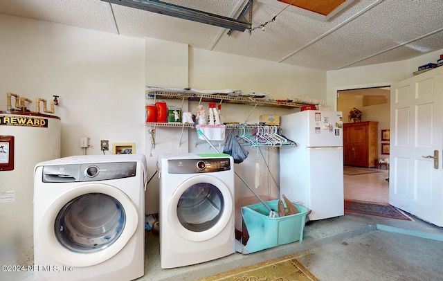 laundry room featuring water heater, washer and dryer, and tile patterned floors