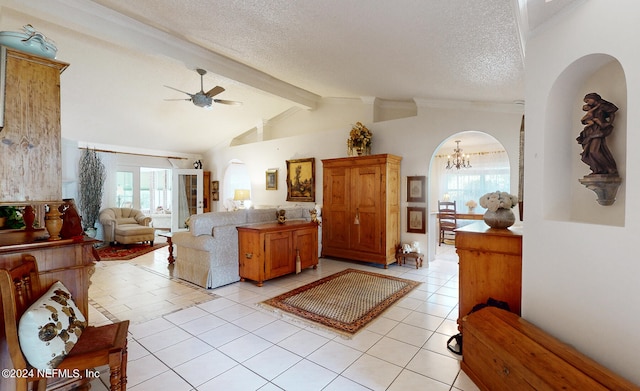 living room with plenty of natural light, light tile patterned floors, and vaulted ceiling with beams