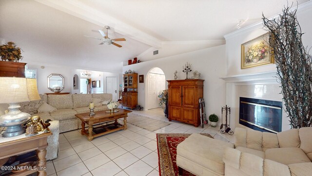 tiled living room featuring ceiling fan and vaulted ceiling with beams