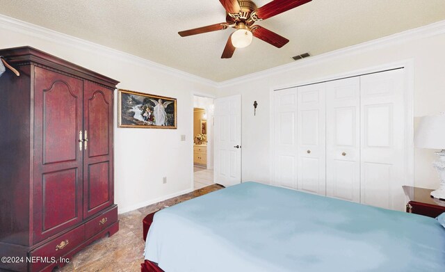 bedroom featuring ornamental molding, a textured ceiling, light tile patterned floors, and ceiling fan