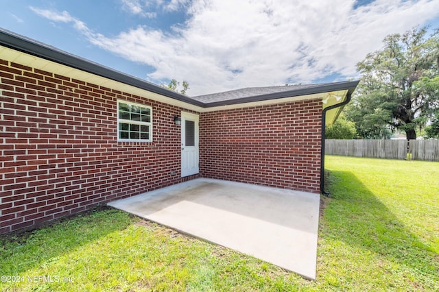 doorway to property featuring a yard and a patio area