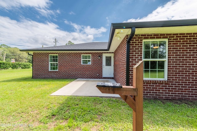 exterior space with a patio and a lawn