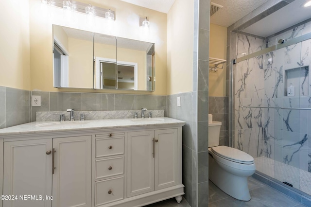 bathroom with an enclosed shower, toilet, tile walls, a textured ceiling, and vanity