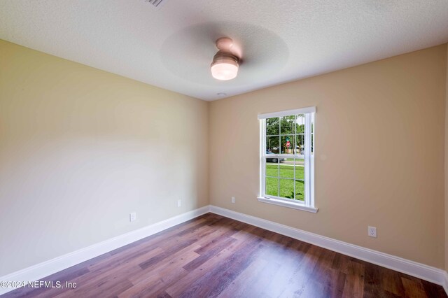 empty room featuring a textured ceiling, ceiling fan, and hardwood / wood-style floors