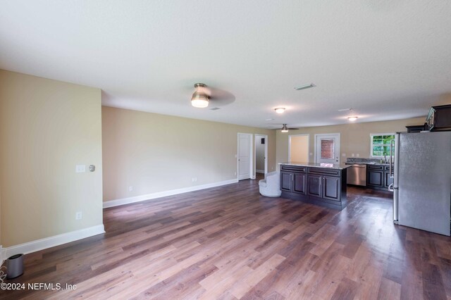 kitchen featuring ceiling fan, stainless steel dishwasher, fridge, and hardwood / wood-style floors