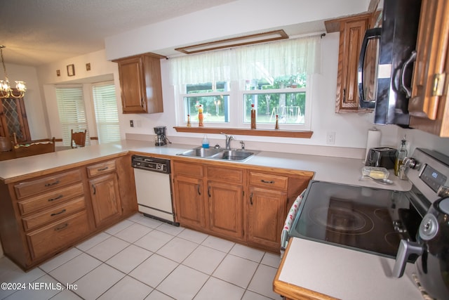 kitchen with sink, dishwasher, light tile patterned floors, stove, and kitchen peninsula