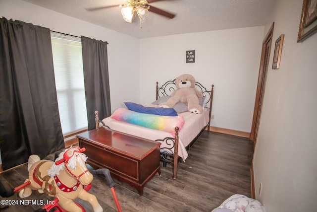 bedroom with ceiling fan, a textured ceiling, and wood-type flooring