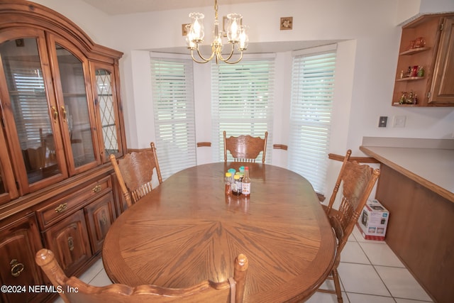 tiled dining area featuring an inviting chandelier