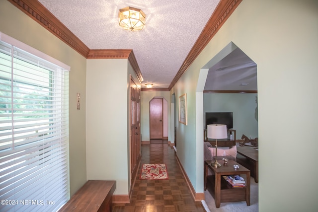 corridor featuring a textured ceiling, crown molding, and parquet flooring