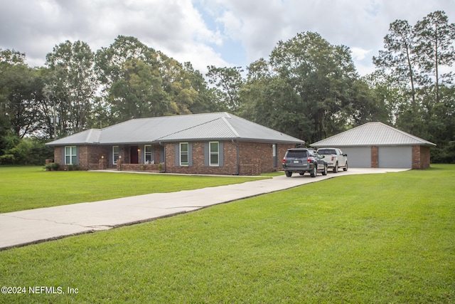 ranch-style house with an outbuilding, a garage, and a front lawn