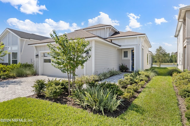 view of front of property with a front yard and a garage