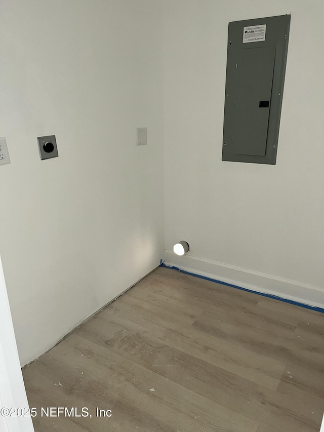 washroom with laundry area, electric panel, light wood finished floors, and electric dryer hookup