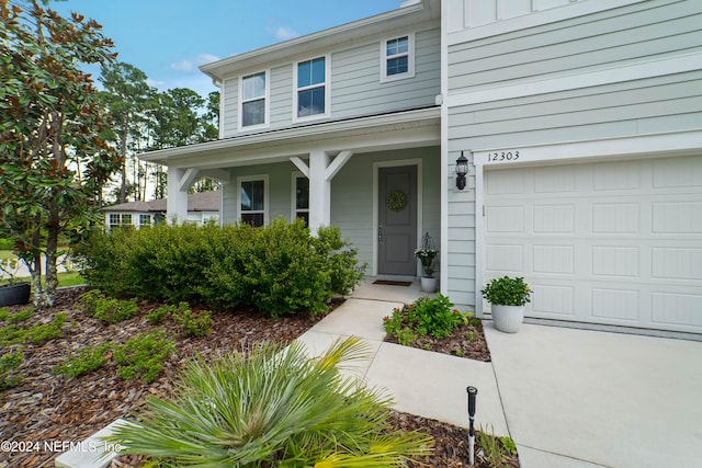 view of front of property with a porch and a garage