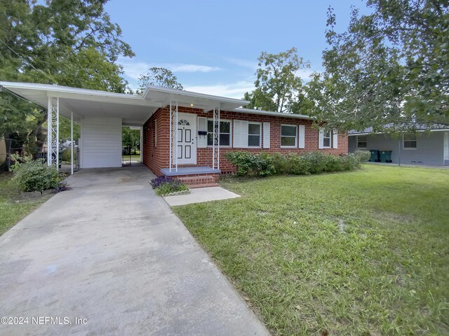 ranch-style house with a front yard and a carport