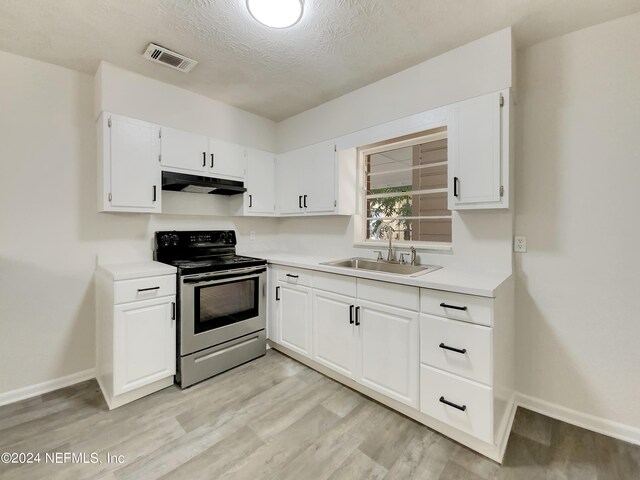 kitchen featuring light wood-type flooring, white cabinetry, stainless steel range with electric stovetop, a textured ceiling, and sink