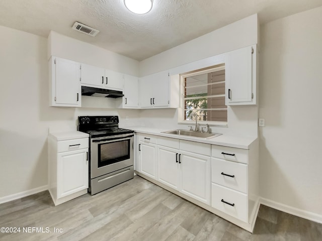 kitchen featuring light wood-type flooring, electric range, sink, a textured ceiling, and white cabinets