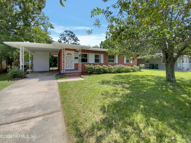 view of front of home with a front yard and a carport