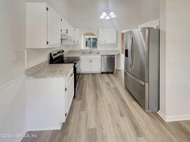 kitchen with sink, white cabinets, light hardwood / wood-style flooring, and appliances with stainless steel finishes