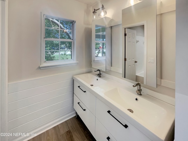 bathroom with hardwood / wood-style flooring and double sink vanity