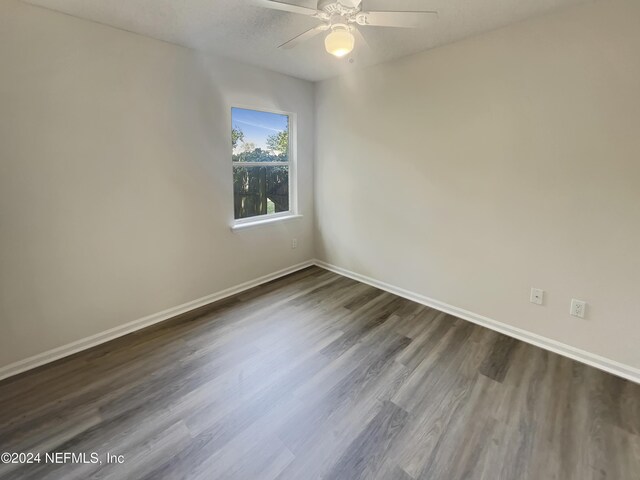 spare room with ceiling fan and hardwood / wood-style floors